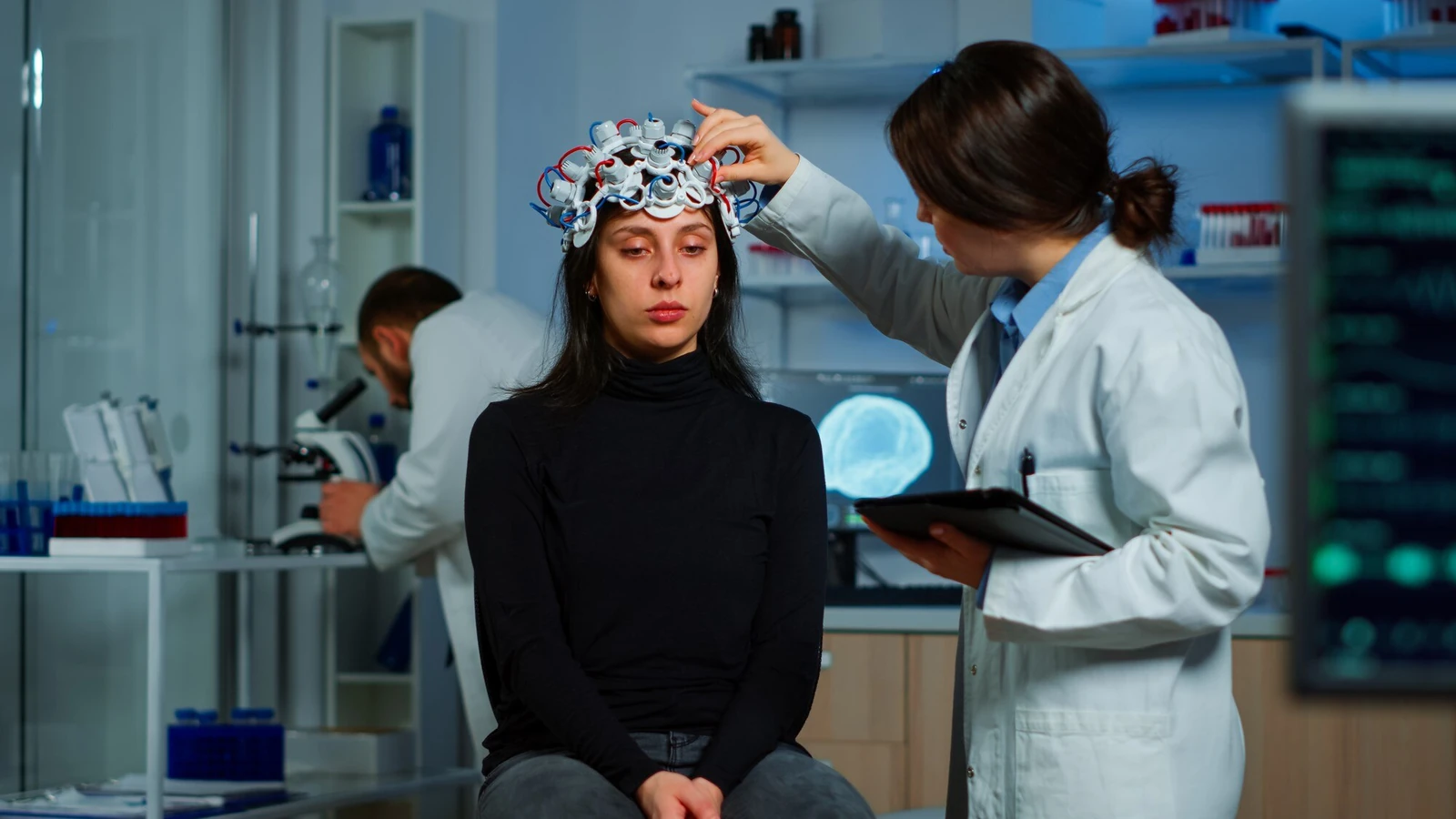 A patient undergoing neurological testing with an EEG headset