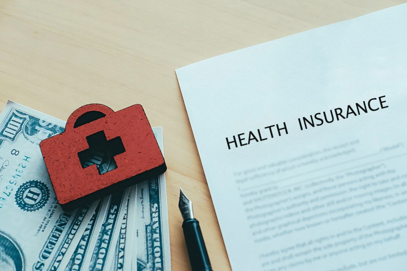 A first aid symbol beside a health insurance document